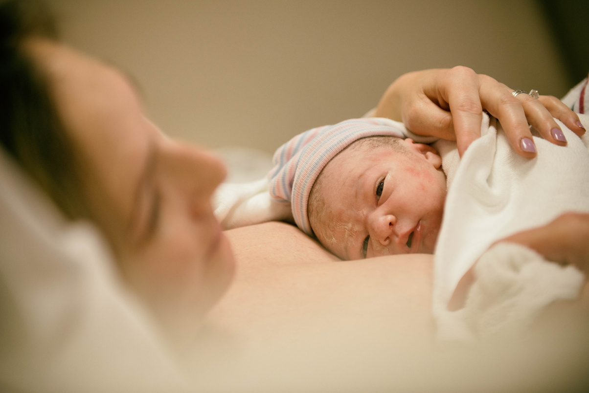 New born opening eyes for the first time after birth